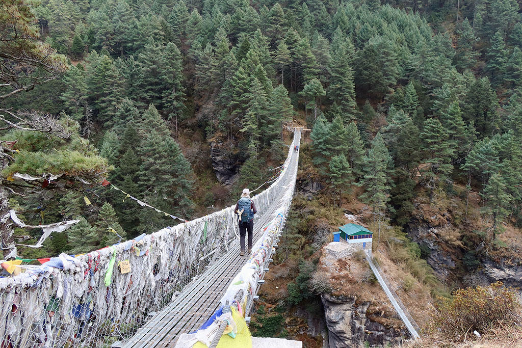 Crossing a suspension bridge while on trek to EBC